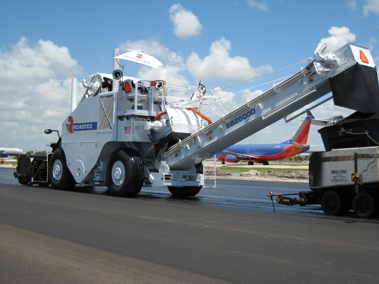 Using a material transfer vehicle in an airport paving application is particularly useful as this minimises material segregation and ensures a steady flow of asphalt to the paver. material transfer vehicle providing steady flow of asphalt